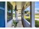 View of a covered porch with hanging plants and decorative elements at 1778 N Salford Blvd, North Port, FL 34286