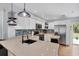 Bright kitchen featuring white cabinets, stainless steel appliances, sleek countertops, and stylish backsplash at 1778 N Salford Blvd, North Port, FL 34286