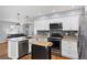 Well-equipped kitchen boasting stainless steel appliances, a functional island, and ample counter space at 1778 N Salford Blvd, North Port, FL 34286