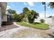 Backyard with jacuzzi, tropical landscaping, manicured lawn, and stone ground cover at 1801 Highland Rd, Osprey, FL 34229