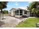 Wide shot of backyard with hot tub and white picket fence, stone and lawn at 1801 Highland Rd, Osprey, FL 34229