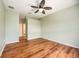 Spacious bedroom with hardwood floors, ceiling fan, and an ensuite bathroom featuring neutral tones at 1801 Highland Rd, Osprey, FL 34229
