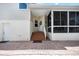 Exterior entryway leading to white door and covered porch with brick steps and landing at 1801 Highland Rd, Osprey, FL 34229