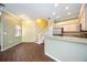 Open kitchen and dining area with granite countertops, stainless appliances, and a staircase leading to the second floor at 1801 Highland Rd, Osprey, FL 34229