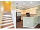 Open kitchen and dining area with granite countertops, stainless appliances, and a staircase leading to the second floor at 1801 Highland Rd, Osprey, FL 34229