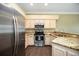 Beautiful kitchen featuring granite countertops, stainless steel appliances, and dark wood flooring at 1801 Highland Rd, Osprey, FL 34229