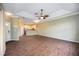 Spacious open-concept living room with modern flooring, ceiling fan, and neutral paint at 1801 Highland Rd, Osprey, FL 34229