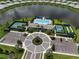 Aerial view of the community pool, tennis courts, and meticulously landscaped grounds of this neighborhood at 18039 Cherished Loop, Bradenton, FL 34211