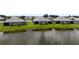 A row of homes is reflected in the serene waterfront view, showcasing backyard landscape at 18039 Cherished Loop, Bradenton, FL 34211
