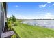 Lush backyard with manicured lawn, landscaping, and serene water view, perfect for relaxation at 18039 Cherished Loop, Bradenton, FL 34211