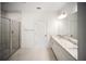 Modern bathroom with double sinks, spacious vanity and glass-enclosed shower for a spa-like experience at 18039 Cherished Loop, Bradenton, FL 34211