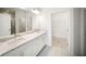 This primary bathroom features double sinks with a stone countertop and modern fixtures at 18039 Cherished Loop, Bradenton, FL 34211