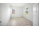 Bright bedroom with neutral walls, tiled floor, and windows offering a view of the street at 18039 Cherished Loop, Bradenton, FL 34211