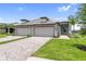Charming single-story home with a well-manicured lawn and a three-car garage on a sunny day at 18039 Cherished Loop, Bradenton, FL 34211