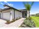 Charming home exterior with well-kept landscaping and a peaceful lake view in the background at 18039 Cherished Loop, Bradenton, FL 34211