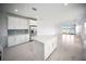 Open kitchen with island, stainless appliances, and view of lake from adjacent living area at 18039 Cherished Loop, Bradenton, FL 34211