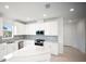 Bright, spacious kitchen featuring white cabinets, stainless steel appliances, and a large center island at 18039 Cherished Loop, Bradenton, FL 34211