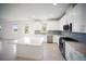 Bright kitchen with a center island, stainless steel appliances, and modern white cabinetry at 18039 Cherished Loop, Bradenton, FL 34211