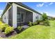 Inviting screened-in lanai with lush landscaping and serene views of the lake at 18039 Cherished Loop, Bradenton, FL 34211