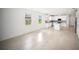 Open floor plan with tile floors connecting living room and modern kitchen at 18039 Cherished Loop, Bradenton, FL 34211
