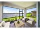 Relaxing screened-in patio featuring comfortable seating and a serene lake view at 18039 Cherished Loop, Bradenton, FL 34211