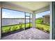 Screened patio offering panoramic views of the lake and landscaped backyard at 18039 Cherished Loop, Bradenton, FL 34211