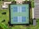 Aerial view of well-maintained, dual pickleball courts surrounded by manicured landscaping and palm trees at 18039 Cherished Loop, Bradenton, FL 34211