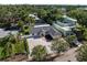 Aerial view of a charming single-story home featuring a pea gravel driveway and lush landscaping at 1881 Orchid St, Sarasota, FL 34239