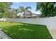 Well-maintained backyard showcasing a lush green lawn and a white privacy fence at 1881 Orchid St, Sarasota, FL 34239