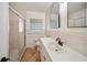 Bathroom featuring a glass shower, stylish vanity, and unique glass block window for natural light at 1881 Orchid St, Sarasota, FL 34239