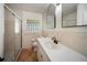 Bathroom features tile floors, glass block window, a vanity with a sink, and shower at 1881 Orchid St, Sarasota, FL 34239