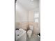 Cozy bathroom with neutral tiling, toilet, and sink at 1881 Orchid St, Sarasota, FL 34239