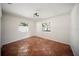 This comfortable bedroom features tile flooring, white walls, and natural light from two windows at 1881 Orchid St, Sarasota, FL 34239
