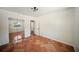 A spacious bedroom has terra cotta tile flooring, a mirror closet, and a white interior door at 1881 Orchid St, Sarasota, FL 34239
