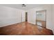 A bedroom with tile flooring features a mirrored closet and white interior doors at 1881 Orchid St, Sarasota, FL 34239