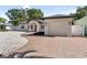 Charming single story home featuring a brick driveway, manicured landscaping, and attached garage at 1881 Orchid St, Sarasota, FL 34239