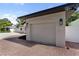 Close up on the attached, single car garage and brick driveway at 1881 Orchid St, Sarasota, FL 34239