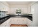 Well-lit kitchen boasts sleek countertops, ample cabinetry, and eye-catching backsplash design at 1881 Orchid St, Sarasota, FL 34239