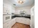 Bright kitchen featuring white cabinetry, stainless steel appliances, and stylish backsplash detail at 1881 Orchid St, Sarasota, FL 34239