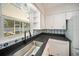 Inviting kitchen area showcasing ample countertop space and a window with backyard views at 1881 Orchid St, Sarasota, FL 34239