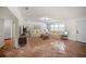 Bright living room featuring terra cotta tile, neutral walls, and dining room access at 1881 Orchid St, Sarasota, FL 34239
