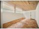 Spacious room featuring a wood ceiling, tiled floors, and natural light from glass block windows at 1881 Orchid St, Sarasota, FL 34239