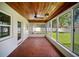 Relaxing screened-in sunroom with ceiling fan and brick floors at 1881 Orchid St, Sarasota, FL 34239