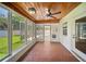 Relaxing screened-in sunroom with ceiling fan and brick floors at 1881 Orchid St, Sarasota, FL 34239