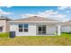 Backyard featuring an outdoor patio, large sliding glass doors, and green grass at 1914 Cobb Trl, Parrish, FL 34219