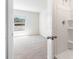 Bathroom featuring a clean, tiled shower stall, window view, and neutral-colored carpet at 1914 Cobb Trl, Parrish, FL 34219
