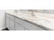 Bathroom featuring dual sinks, white marble countertops, and white cabinets at 1914 Cobb Trl, Parrish, FL 34219