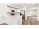 Bright kitchen featuring stainless steel appliances, stone counters, and hardwood floors at 1914 Cobb Trl, Parrish, FL 34219