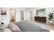 Comfortable bedroom featuring neutral carpet, a TV, and a large window offering plenty of natural light at 1922 Cobb Trl, Parrish, FL 34219