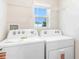 Practical laundry room featuring new Whirlpool washer and dryer and plenty of natural light at 1922 Cobb Trl, Parrish, FL 34219